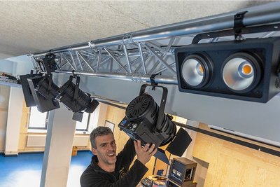 Jan Gabriel installiert die Licht- und Bühnentechnik im Saal auf der Veranstaltungsebene.