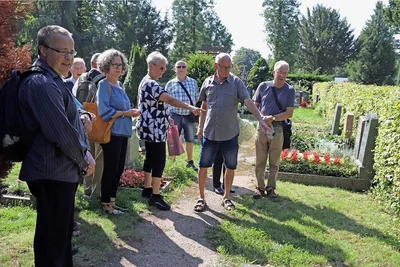 Dieter Gneiser (2. v. r.) zeigt Gästen die Stelle auf dem Donatsfriedhof, an der einst das Grab seines Bruders Rainer zu finden war. 