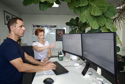 Geschäftsführerin Antje Wolfeil und Software-Entwickler Michael Walther besprechen neue Projekte am Computer.