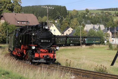 Ein Zug der Fichtelbergbahn fährt auf dem Weg nach Oberwiesenthal durch die Ortslage Neudorf.