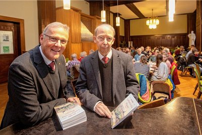 Pfarrer Andreas Gräßer und Autor Frank Weiß präsentieren die neue Chronik über die Plauener Lutherkirche. 