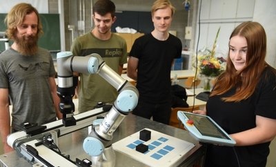 Die Roboter-Technik soll das Interesse bei angehenden Lehrlingen für Berufe in der Industriebranche wecken. Berufsschullehrer Christian Scheer (links) hat zusammen mit den Azubis Max Fuchs Anthony Thierbach und Esmeralda Pätz (von links) den Roboter am Berufsschulzentrum in Oelsnitz vorgeführt. 