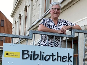 Daniela Böttger am Eingang der Burkhardtsdorfer Bibliothek, die sich im Keller des Schulgebäudes befindet. Seit 2021 hat sie die Leitung inne, unterstützt wird sie von zwei Seniorinnen - überwiegend im Ehrenamt. 