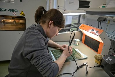 Mitarbeiterin Lilia Seifert beim Bestücken von Leiterplatten.