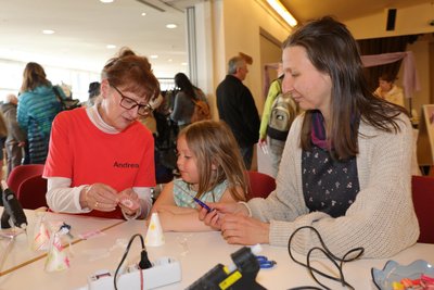 Andrea Wezel (links) leitet Emmi und ihre Mutter Sarah Lenk beim Basteln an. Kleine Frühlingsengel sollen dabei entstehen.