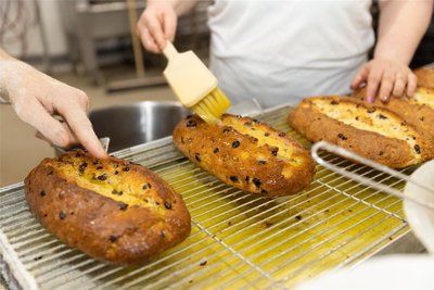 Jede Menge Butter wird auf die goldbraun gebackenen Stollen gestrichen. Erfahrungswerte zählen: Zu viel Butter macht den Stollen schlierig. Ist es zu wenig Butter, wird er trocken.