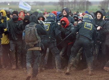 Erkelenz: Polizisten drängen Demonstranten am Rande des Braunkohletagebaus bei Lützerath zurück.