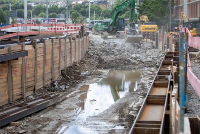 Fünf Meter tief ist das Loch, durch das bald wieder die Syra fließen soll. Durch das schwarze Rohr links oben wird das Wasser zurzeit mit Druck gepumpt. Wo die Bagger der Baufirma Keßler stehen, verläuft später die Straße.