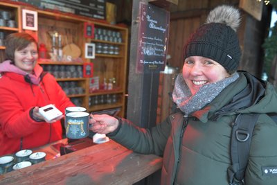 Antje Gottwald (r.) kauft bei Karoline Trabelsi auf dem Freiberger Christmarkt zwei Glühwein.