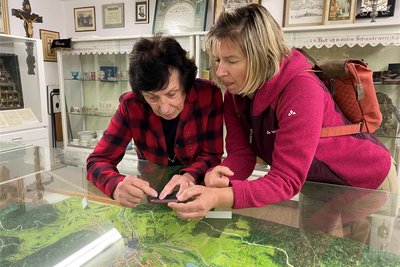 Anita Donderer mit Museumsbesucherin Dagmar Hach bei der Suche nach ihrem Geburtshaus.