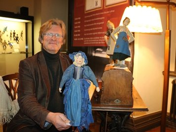 Museumsdirektor Rainer Koch mit drei der Puppen von Brunhilde Einenkel, die derzeit in einer Sonderausstellung im Unteren Schloss Greiz zu sehen sind. 