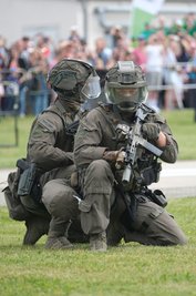 Polizisten vom Spezialeinsatzkommando in Spezialkleidung und mit Waffen bei einer Vorführung. 