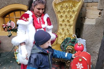 Adventszauber in Schönfels fällt ins Wasser - aber nur im Wortsinne - Gemeinsam mit der Weihnachtsfrau Ines Volkmer steckt der fünfjährige Carl seinen Wunschzettel in den Weihnachtsmannbriefkasten