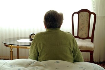 Alkohol- und Tablettensucht im Alter: Ein verstecktes Problem in Freiberg - Eine ältere Frau sitzt in ihrem Schlafzimmer auf dem Bett, aufgenommen in Frankfurt am Main.