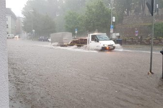 Amtliche Unwetterwarnung des Wetterdienstes: Was im Vogtland bereits passierte und bis Freitagfrüh noch zu erwarten ist - Land unter auf der Grabenstraße in Oelsnitz: Die zum Heppeplatz führende Straße stand am Donnerstagnachmittag unter Wasser.