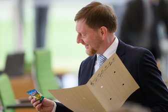 „Andere Platte auflegen“: Wenn sich Kretschmer im Landtag vom AfD-Chef provoziert fühlt - Sachsens Ministerpräsident Michael Kretschmer (CDU) vor Beginn der Landtagssitzung mit Gummibärchen.