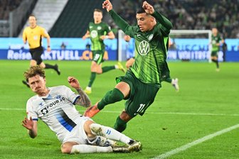 Aufstiegstraum lebt: Paderborner Weg vor Krönung? - Hartnäckiger Außenseiter: Paderborns Calvin Brackelmann (l) stoppt den Wolfsburger Adam Daghim im Relegations-Hinspiel.
