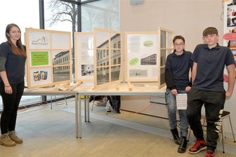 Ausflüge und Arrestzelle: Jugendliche forschen zum DDR-Jugendwerkhof in Brand-Erbisdorf - Der 15-jährige Ian (rechts) und der 13-jährige Marco gehören zu den Jugendlichen aus Brand-Erbisdorf, die zum dortigen Jugendwerkhof geforscht haben. Aline Marschner leitet das Kinder- Jugend- und Familienzentrum JUFZ. Nicht im Bild die bisherige Leiterin Heike Lorenz. Im Holz-Fensterrahmen das Gebäude des Jugendwerkhofs.