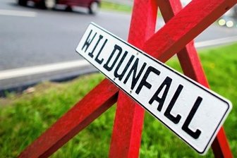 Autos kollidieren mit Wildschweinen - Das Symbolfoto zeigt ein Dreibein am Straßenrand. Es weist auf einen Wildunfall hin.