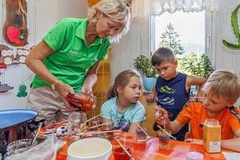 Bank dreht Zwergenstadt in Oberwiesenthal Geldhahn zu - Auch in diesen Sommerferien gab es eine Wiesenthaler Zwergenstadt. Hier ein Blick in die Kreativwerkstatt, in der Jonetta Singer vom Verein Familienzentrum Oberwiesenthal mit Paula aus Oberwiesenthal sowie den Bärensteinern Lennox und Ben (v. l.) Gelkerzen herstellte. 
