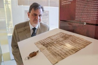 Bevor die Katastrophe eintritt: Chemnitzer Archive und Museen gründen einen Notfallverbund - Raymond Plache, Leiter des Staatsarchivs Chemnitz, betrachtet das älteste in Chemnitz aufbewahrte Dokument, die Gründungsurkunde des Klosters Geringswalde aus dem Jahr 1233.