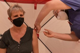 Bisher 1585 Impfungen im Krankenhaus - Nach Terminbuchung kann man sich jetzt auch im Kulturbahnhof gegen Covid-19 impfen lassen. Im Foto: Angela Keller aus Thalheim ließ sich am Dienstag von Andre Klinger, Chirurg am Helios Klinikum Aue, die Booster-Impfung geben. Im Krankenhaus ist das Impfen ohne Termin möglich.