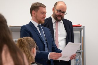 Böse Überraschung zum neuen Schuljahr: Sachsen stoppt Einstellungsverfahren für neue Schulassistenten - Ministerpräsident Michael Kretschmer (CDU) und Kultusminister Christian Piwarz (beide CDU) bei einem Schulbesuch im Januar – und somit nicht bei der gemeinsamen Lektüre der Hiobsbotschaft zur fehlenden Finanzierung bereits versprochener Schulassistenten.