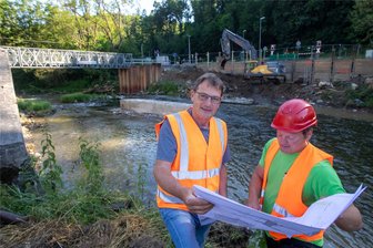Brücke ade: Jetzt wird das marode Bauwerk in Barthmühle abgerissen - Schon am vergangenen Freitag haben die Abrissarbeiten an der maroden Brücke im Pöhler Ortsteil Barthmühle begonnen. Bislang läuft alles nach Plan, so Bauleiter Volker Reinhardt (links) und Polier Marcel Leuschner.