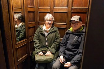 Cammann-Hochhaus Chemnitz: Mit dem Fahrstuhl in die Vergangenheit - Maria und Günter Greif aus Chemnitz testen bei einer Ausstellungseröffnung im Cammann-Haus den historischen Fahrstuhl.
