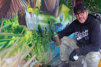 Carolas Garten blüht nun auch in Auerbach - Eine Woche hat der Graffiti-Künstler Tasso gebraucht, um eine gelbe Carportwand in diese grüne Oase zu verwandeln. 