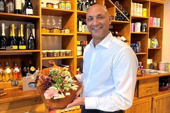 „Casa Mia“ bietet italienische Köstlichkeiten mitten in Reichenbach - Auf einem Brett hat Angelo Strano am Eröffnungstag Kostproben für die Kunden angerichtet: darunter Schinken, Käse, Weintrauben, Feigen. Den großen Schrank im Hintergrund hat ein Freund für den Laden per Hand angefertigt.