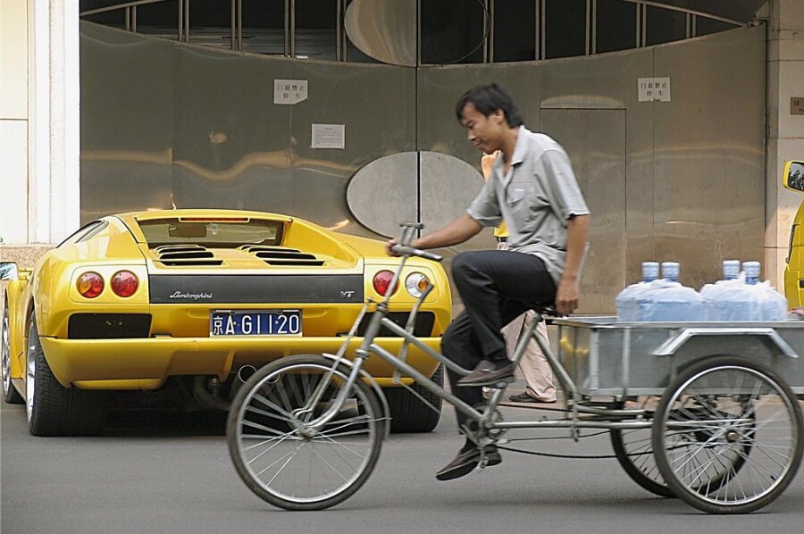 China stellt die Verteilungsfrage - Kontraste in Peking: Ein Dreirad-Auslieferungsfahrer strampelt an einem Lamborghini vorüber, dessen Kaufpreis von über 200.000 Euro wohl seinem 200-fachen Jahreseinkommen entspricht. In Chinas Volkskongress sitzen viele Milliardäre und Multimillionäre, die jedes Jahr reicher werden. 