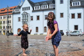 Das erste Frühsommer-Wochenende in Freiberg: Tipps für Familien, die Abkühlung suchen - Linda (4) und Helen (8) aus Zwickau kühlten sich am Samstag auf dem Obermarkt ab. Und zwar richtig. 