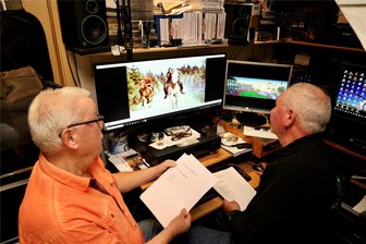 Der wilde Westen im Greifensteinwald: Erzgebirger zeigen unbekannte Filme - Wolfgang Lohr (links) und Steffen Gerstenberger bereiten den Filmabend vor. Auf dem Bildschirm sieht man eine Szene des Western-Streifens.