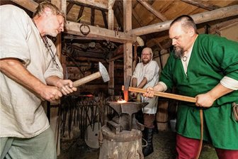 Drei Tage lang Feierlaune in der mittelalterlichen Bergstadt Bleiberg in Frankenberg - Von links: Thilo, Matthias und André schmiedeten am Amboss mit Muskelkraft ein historisches Werkzeug