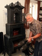 Erinnerung an Reisigfeuer und Blümchenkaffee - 
              <p class="artikelinhalt">Sogar Schuhe konnte man zum Anwärmen in den eisernen Ofen stellen, wie Bürgermeister Gunther Kaden demonstriert.</p>
            