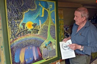 Erzgebirgischer Künstler will mit Kriegs-Triptychon aufrütteln - Künstler Werner Franz in seinem Atelier in Grumbach, wo er derzeit ein Werk zum Thema Russland-Ukraine-Krieg fertigstellt. In der Hand hält er eine Beschreibung des Signets des Europäischen Gerichtshofs für Menschenrechte, welches er in das Triptychon einarbeitet.