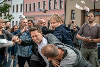 Erzgebirgskrimi am Rand zum Vogtland - Maik in Not: Kommissar Robert Winkler (Kai Scheve, 3. von rechts) muss Maik (Adrian Topol, Mitte) aus einer brenzligen Situation auf dem Marktplatz retten. Hinten links mit den langen Haaren als Teil der wütenden Menge: Komparsin Yvonne Scheithauer. 