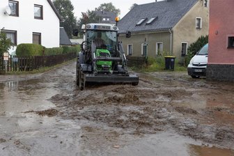 Extreme Gewitter lösen Schlammlawine im Erzgebirge aus: Wasser dringt in Grundschule - Wassermassen mit Schlamm und Geröll haben in Sehma die Fabrikstraße überflutet.