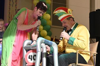 Fasching in Bad Elster mit Prinzenpaar-Sharing und „Emmel“-Ehrung - Präsidentin Heike Geipel ehrte den Moderator Matthias „Emmel“ Lenk für seine 40-jährige Faschingstreue - narrengemäß mit einer symbolischen Gehhilfe.