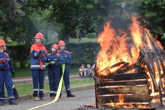 Feuerwehr Geringswalde lässt es zum Jubiläum lodern - Noch wartet die Jugendwehr bei der Schauübung auf die Wasserversorgung, um die Flammen am Schuppen zu löschen.
