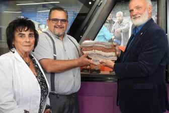 Freiberg: Achate im Foyer der „Terra mineralia“ zu bestaunen - Monika und Tim Haake (Frau und Sohn von Reiner Haake) setzen mit Kustos Andreas Massanek einen der ausgestellten Achate in die Vitrine im Foyer der Terra mineralia.