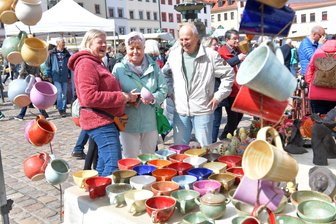 Freiberger Töpfermarkt - das Problem hinter dem beliebten Handwerk - Fröhliche Farben bei Töpfermeisterin Andrea Soika (l.) aus Potsdam, die Brigitte und Stefan Saupe aus Freiberg berät.