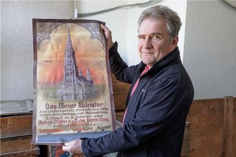 Fund in zig Kisten: Das Ulmer Münster aus Holz kommt in Geyer ans Licht - Helmut Müller, Vorsitzender des Schnitz- und Krippenvereins Geyer, zeigt ein altes Plakat, das mit einer hölzernen Nachbildung des Ulmer Münsters wiedergefunden worden ist.