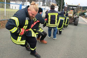 Gaudi-Traktorwettstreit bei Kirmes im Vogtland: Volle Kraft voraus für ein Fass Bier - Die Jungs von der Feuerwehr Rothenkirchen gingen konzentriert ans Werk. Gewonnen hat aber ein anderes Team.