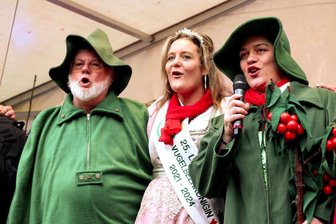 Geschlechterwettstreit: Stimmgewaltiger Chor singt das Lied vom Vugelbeerbaam - Lautergold-Betriebsleiter Mike Schneisig, das Vugelbeermannel, Königin Sandra Göthel und Kaiserin Conctance Brosell stimmen das Steigerlied an. Weil sie eine Wette verlor, musste Brosell sich als Vugelbeermannel verkleiden.