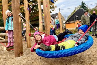Helbigsdorf weiht neuen Spielplatz ein – Muldas Bürgermeister: „Ein wunderschönes Kleinod“ - Haben sichtlich Spaß an der neuen Vogelschaukel: Janek (aus Helbigsdorf 5), Lina (8) und Emma (5) aus Mulda (v.r.).