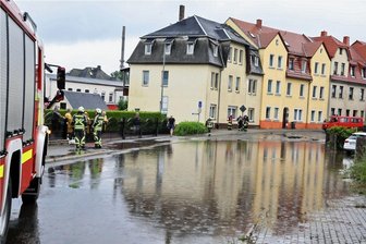 Hohenstein-Ernstthal: Warum fließt das Wasser auf der August-Bebel-Straße nicht ab? - Am 29. Juni 2021 war die August-Bebel-Straße in Hohenstein-Ernstthal großflächig überschwemmt. Die Feuerwehr sicherte die Gefahrenstelle. Die Straße musste komplett gesperrt werden.