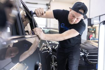 „Ich freue mich, wenn es hagelt“: Wie ein Spätaussiedler zum Dellendoktor im Vogtland wurde - Rinat Brandt beim Entfernen von Dellen im Autoblech. Er profitiert von Unwetter- und Hagel-Ereignissen. Dann rennen ihm die Kunden die Werkstatt ein. Die will er gern vergrößern.