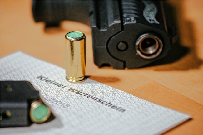 Immer mehr Sachsen beantragen "Kleine Waffenscheine" - Ein kleiner Waffenschein liegt zwischen einer Schreckschuss-Pistole "Walther P22", einem Magazin und einer Platzpatrone. (Archiv)